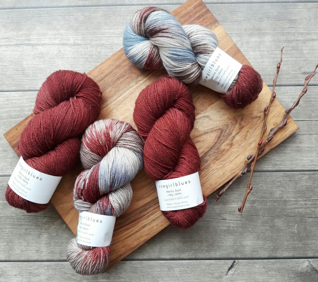 pexels-photo-2399122 Vibrant yarn skeins on a wooden board, perfect for knitting and crafting enthusiasts.
